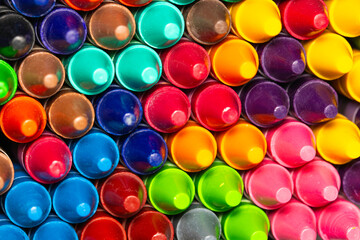 Colourful stacked wax crayons.