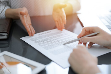 Obraz premium Businesswoman lawyer pointing into contract special points admitting something for colleague or client at meeting. Business people teamwork and partnership