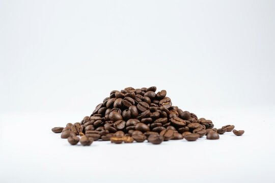 A stack of coffee beans on a white background with a white border top and bottom. Generative AI