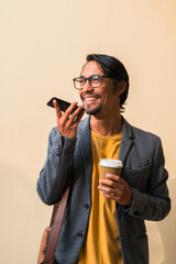 Fototapeta premium Happy man recording a joyful voice message.