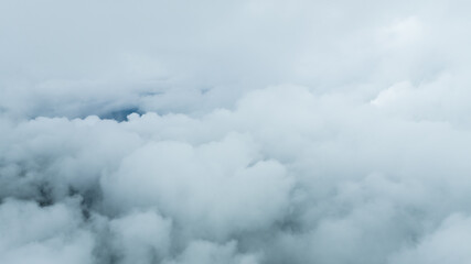 Aerial photographs were taken with a latest generation drone above dense gray clouds. Sky above the...