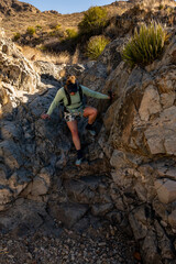 Backpacker Climbing Down Rocks In Big Bend