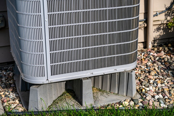 Selective focus on an air conditioner pad to level and hold the unit off the ground. © Lost_in_the_Midwest