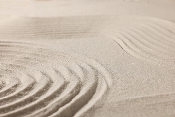 Beautiful lines drawn on sand, closeup. Zen garden