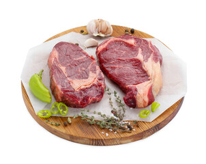 Pieces of beef meat with thyme and spices on white background