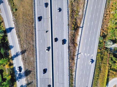 Aerial view of busy highway 400 road with fast moving traffic and exit around Great Toronto Area.