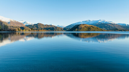 Dawn scenery at Glendhu bay campground  looking across Lake Wanaka towards the snow capped mountains in Mt Aspiring National Park