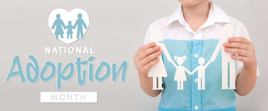 Child holding human figures on light background