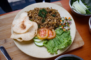 Fried rice, a typical Indonesian food with a mixture of tomatoes, cucumbers and crackers in the Indonesian Food Festival.