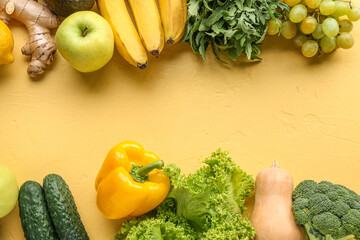 Different fresh vegetables and fruits on yellow background