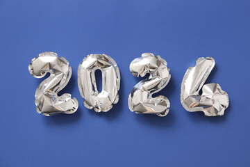 Figure 2024 made of balloons on blue background