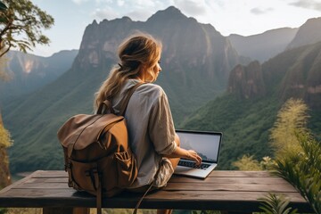 Fototapeta premium Digital nomad working on a laptop with a breathtaking mountain view created with Generative AI