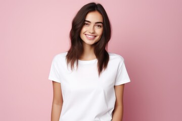 Fototapeta premium A woman posing in front of a vibrant pink wall