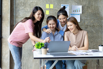 Colleagues meeting to discuss work plan on laptop in office. Group of university students working together in the library.