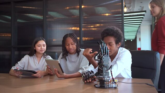 Group of international or multi ethnicity student having a discussion together about science project in class room.