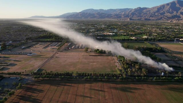 Plume of smoke travels across the Coachella Valley to the Salton Sea as a pile of mulch burns in the Empire Polo Fields
