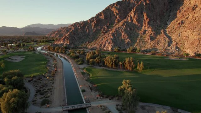 Sunrise aerial view of La Quinta mountains, surrounded by golf courses and resort communities