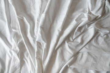 Top view of wrinkles on an unmade bed sheet 