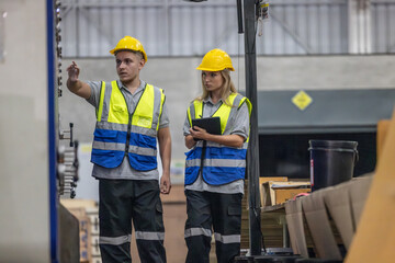 Techs inspecting, maintaining cardboard machine for safety, uninterrupted, high-quality production.