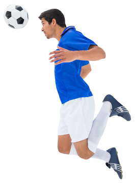Digital png photo of caucasian male soccer player bouncing ball on transparent background
