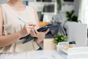 ฺbusinesswoman holding tablet standing at modern office looking at camera. business professional or support partnership. HR officers make presentations for employees in organization.