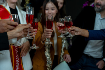 Group of office workers celebrate Christmas and New Year by dancing and drinking wine. Group of international friends and boss dancing with employees.