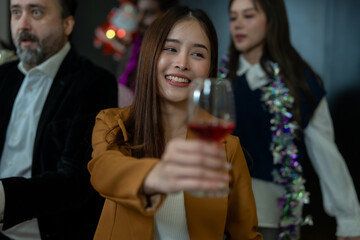 Group of office workers celebrate Christmas and New Year by dancing and drinking wine. Group of international friends and boss dancing with employees.