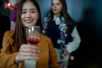Group of office workers celebrate Christmas and New Year by dancing and drinking wine. Group of international friends and boss dancing with employees.
