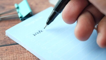 writing on a daily planner on table.