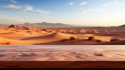 Naklejka premium Wooden table top on blur desert background. For montage product display. View of copy space. 