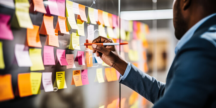 Business Team Brainstorming: Guy Jotting Down Suggestion on Glass Wall