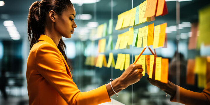 Business Team Brainstorming: Woman Jotting Down Suggestion on Glass Wall