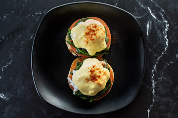 A top down view of a plate of eggs Benedict.