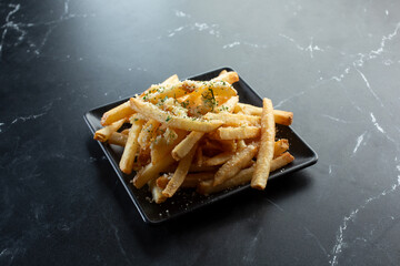 A view of a plate of garlic parmesan fries.