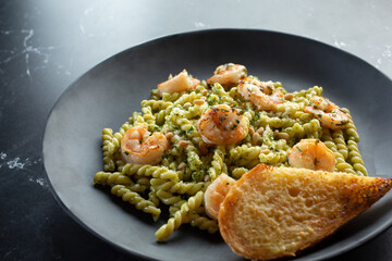 A view of a plate of gemelli shrimp pesto.