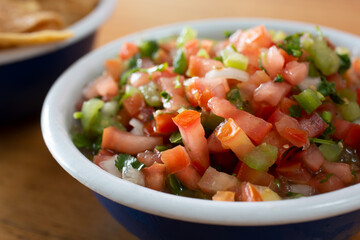 A closeup view of a bowl of pico de gallo salsa.