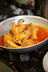A view of chicken wings cooking in a pan.
