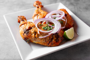 A view of a plate of tandoori chicken.
