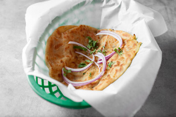 A view of a basket of aloo paratha.