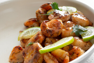 A view of a plate of glazed shrimp.