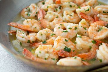 A view of a pan of sauteed garlic shrimp.