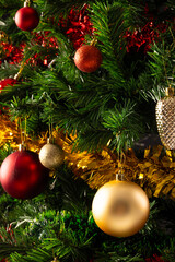 Vertical image of close up of christmas tree with baubles and decorations with copy space