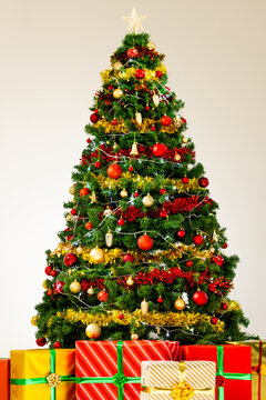 Vertical image of christmas tree with decorations and gifts with copy space background