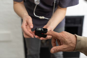 Nurse use pulse oximeter to check patient's oxygen in home , Home healthcare service concept.