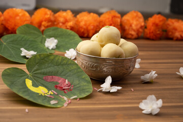 Indian festival dussehra , green leaf, rice and flowers ans sweet pedha