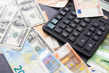 Euro and dollar notes. euro against dollar. A closer look of the president of the USA with a dollar bill, peeping out from behind a euro bill. USA and Europe finance relation. Close up top view.