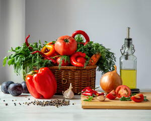 Chili peppers with parsley, dill, bell pepper, tomatoes, garlic, olive oil and spices on a white table