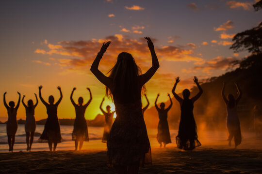 Yogis greeting New Years dawn with sun salutations on tropical sands 