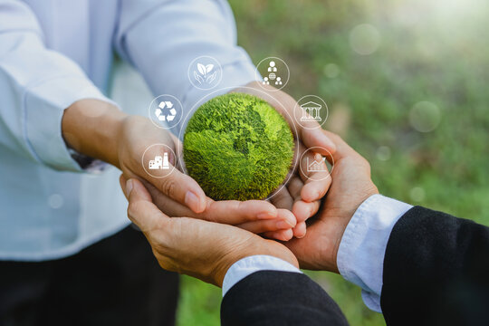 Hand of Business man holding green earth  and ESG icon for Environment Social and Governance, World  Sustainable Environment technology concept.