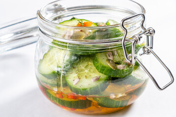 Jar with tasty fermented cucumbers